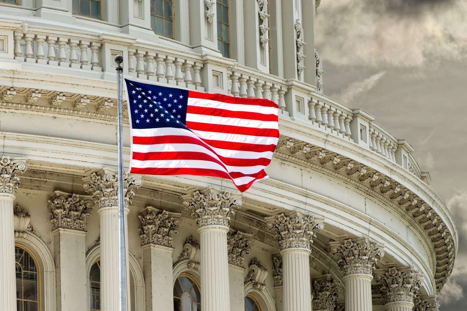 38419767 - washington dc capitol dome detail with waving american flag